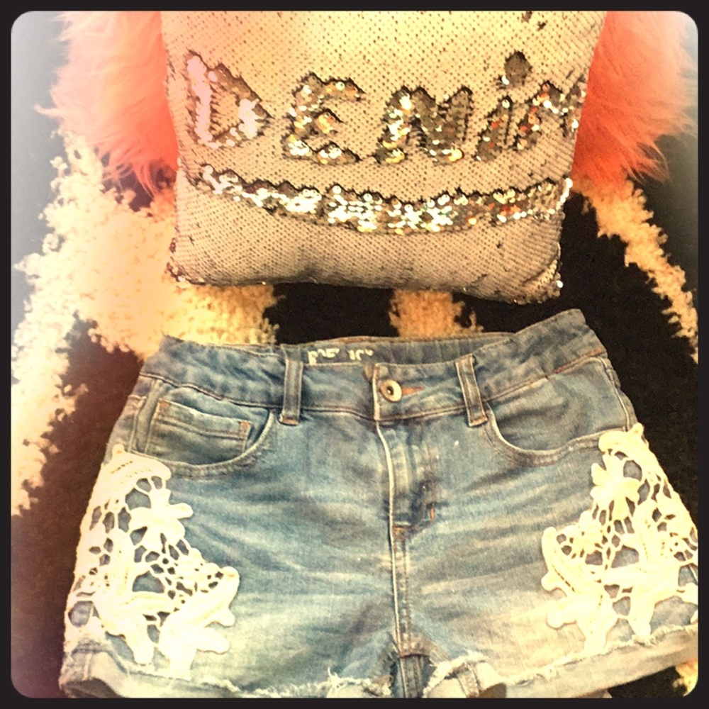 Denim shorts with lace on the sides.